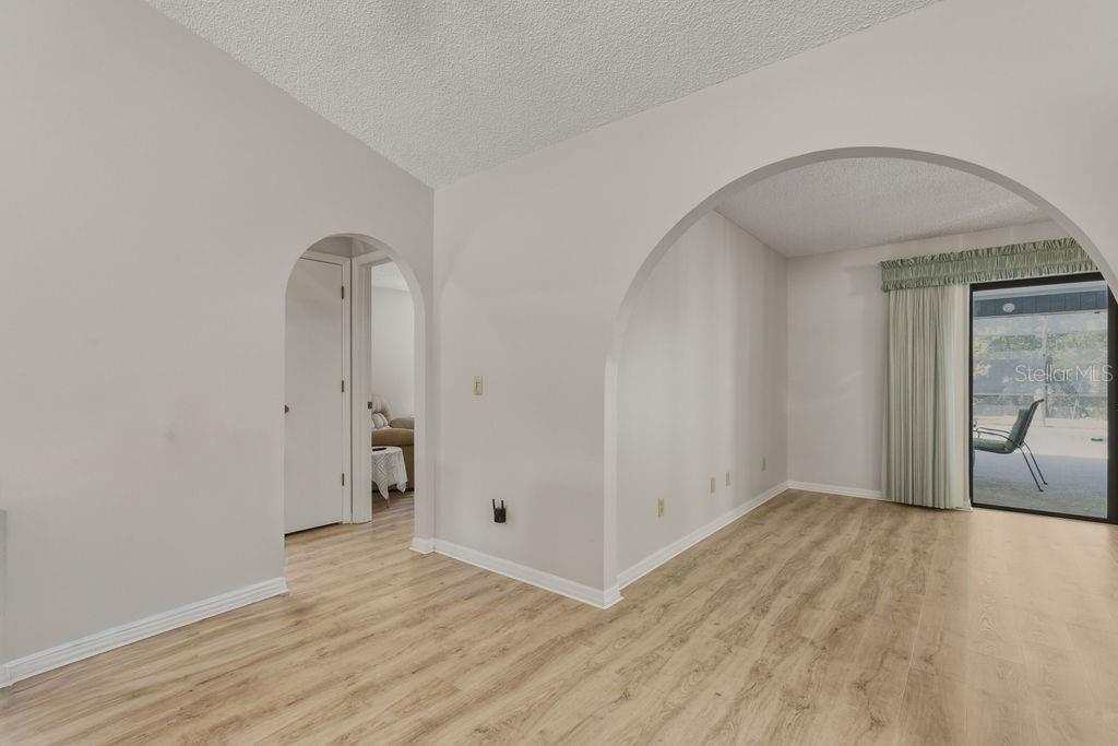 8873 Southwest 200th Circle Dunnellon, FL 34431 - Photo 13 of 61 an empty room with wooden floor and mirror