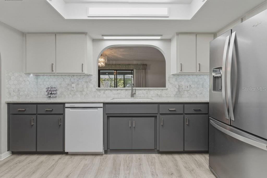 8873 Southwest 200th Circle Dunnellon, FL 34431 - Photo 14 of 61 a kitchen with granite countertop a sink and refrigerator