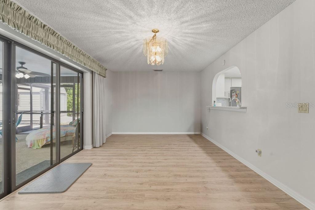 8873 Southwest 200th Circle Dunnellon, FL 34431 - Photo 17 of 61 wooden floor in an empty room with a window