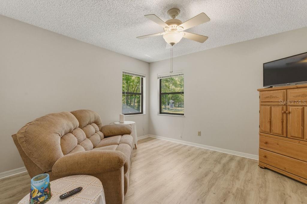 8873 Southwest 200th Circle Dunnellon, FL 34431 - Photo 18 of 61 a living room with furniture a ceiling fan and a window