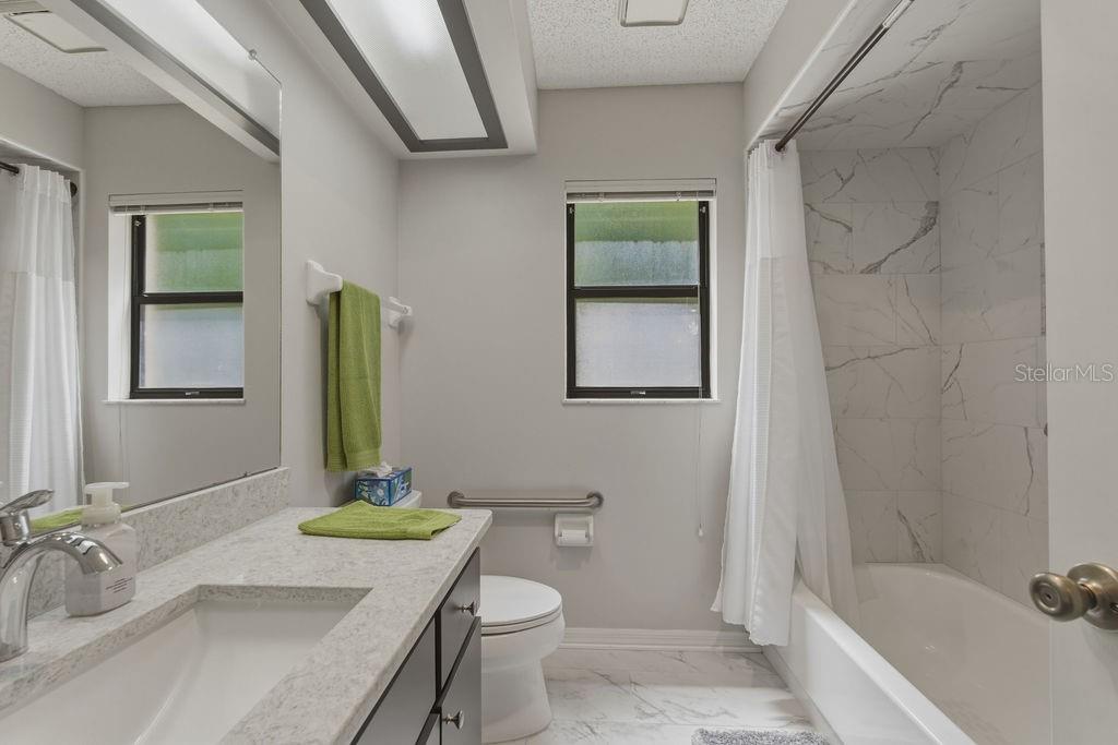 8873 Southwest 200th Circle Dunnellon, FL 34431 - Photo 20 of 61 a bathroom with a granite countertop sink a toilet and shower