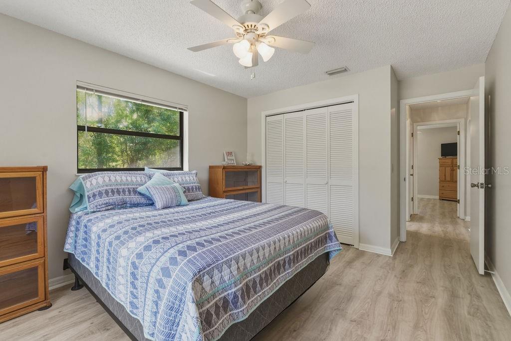 8873 Southwest 200th Circle Dunnellon, FL 34431 - Photo 22 of 61 a bedroom with a bed and a chandelier
