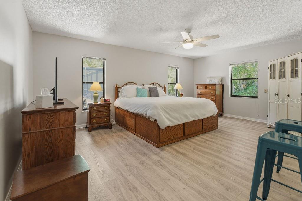 8873 Southwest 200th Circle Dunnellon, FL 34431 - Photo 24 of 61 a large bedroom with a bed and large mirror on the dresser