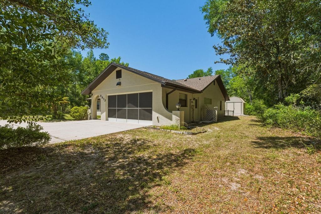 8873 Southwest 200th Circle Dunnellon, FL 34431 - Photo 39 of 61 a front view of a house with a garden