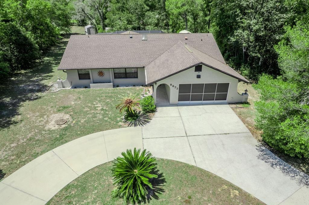8873 Southwest 200th Circle Dunnellon, FL 34431 - Photo 4 of 61 a front view of a house with a garden and plants