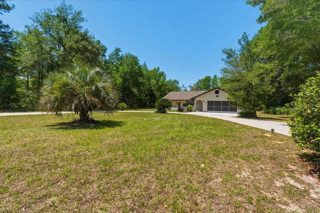 8873 Southwest 200th Circle Dunnellon, FL 34431 - Photo 44 of 61 a swimming pool with outdoor seating and yard