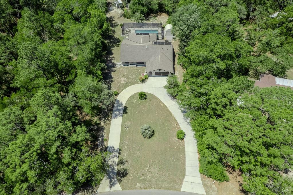 8873 Southwest 200th Circle Dunnellon, FL 34431 - Photo 6 of 61 an aerial view of a house with a yard and trees all around