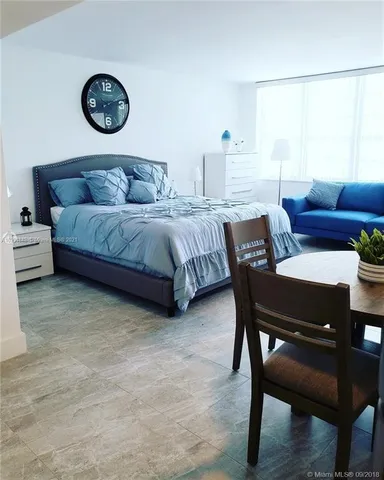 a bedroom with a bed and a table in it