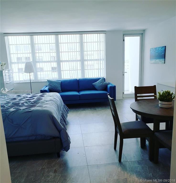 100 Lincoln Road, Unit 707 Miami Beach, FL 33139 - Photo 6 of 12 a bedroom with a bed and a table