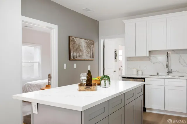 a kitchen with a sink cabinets and wooden floor