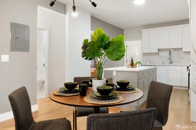 a dining room with furniture and a potted plant