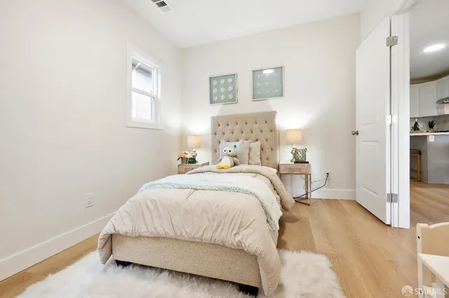 a bedroom with a bed and a painting