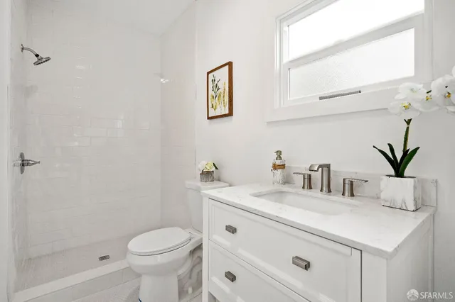 a bathroom with a sink a toilet and a mirror