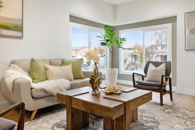 a living room with furniture and a potted plant