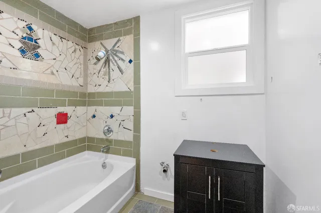 a bathroom with a bathtub and a shower