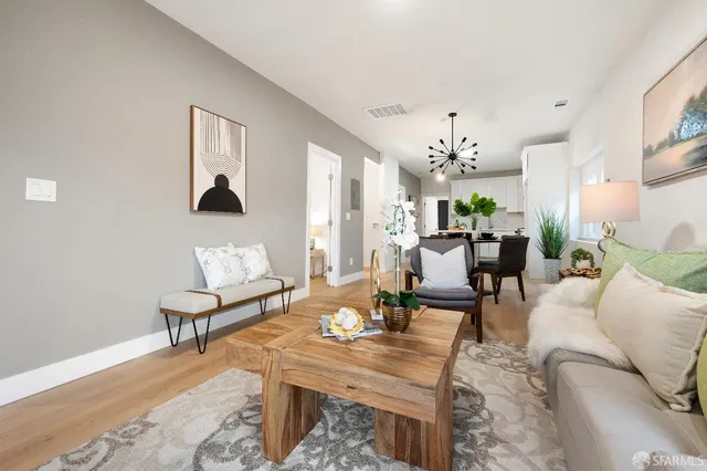 a living room with furniture and a chandelier