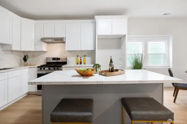 a kitchen with a sink cabinets and a window