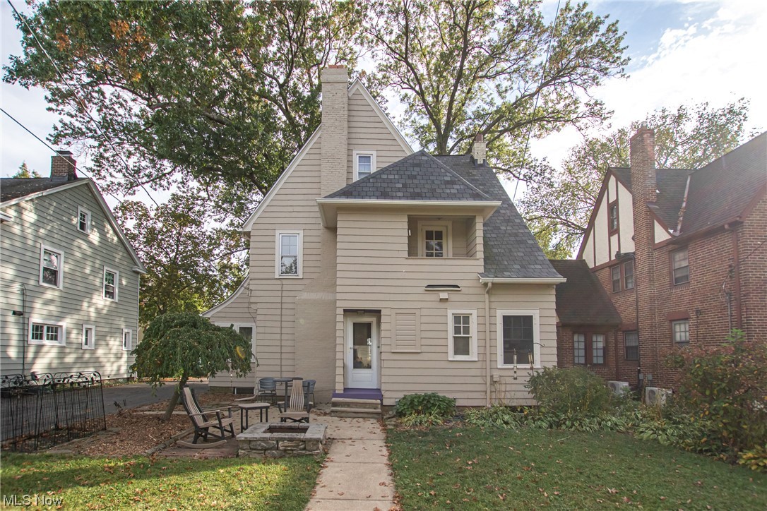 15911 Fernway Road Cleveland, OH 44120 - Photo 32 of 32 Back of house with a yard and a fire pit