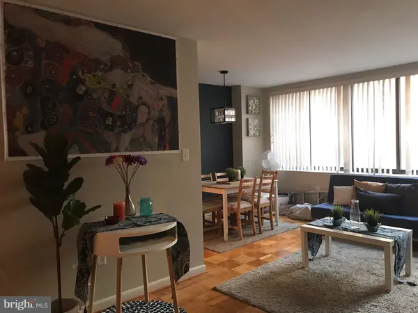 a living room with furniture a rug and a window