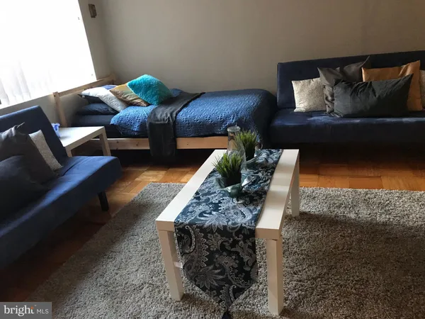 a living room view with a furniture and entryway