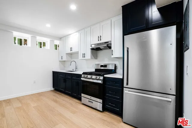 a kitchen with stainless steel appliances a refrigerator stove and sink