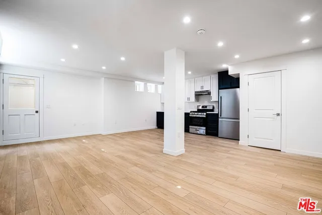a view of kitchen with refrigerator and microwave
