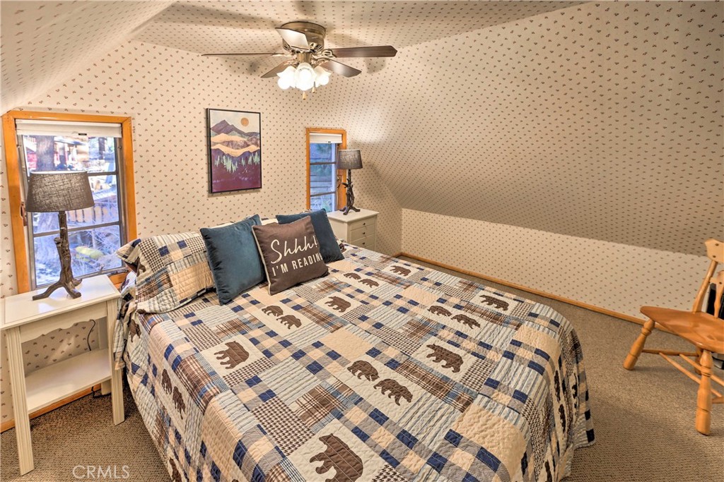 1069 Eagle Road Wrightwood, CA 92397 - Photo 14 of 24 a bedroom with a bed and wooden floor