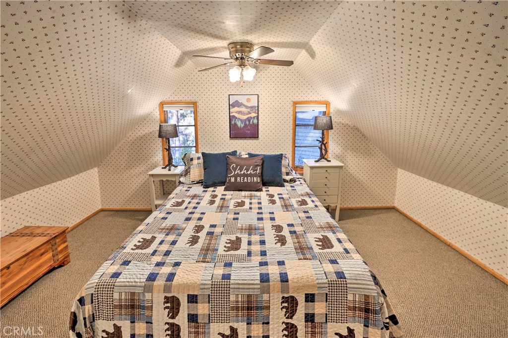 1069 Eagle Road Wrightwood, CA 92397 - Photo 16 of 24 a bedroom with a bed and a chandelier