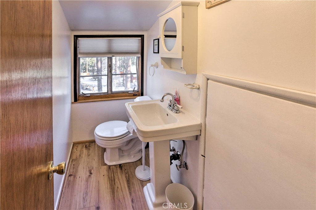 1069 Eagle Road Wrightwood, CA 92397 - Photo 17 of 24 a bathroom with a sink toilet and a mirror