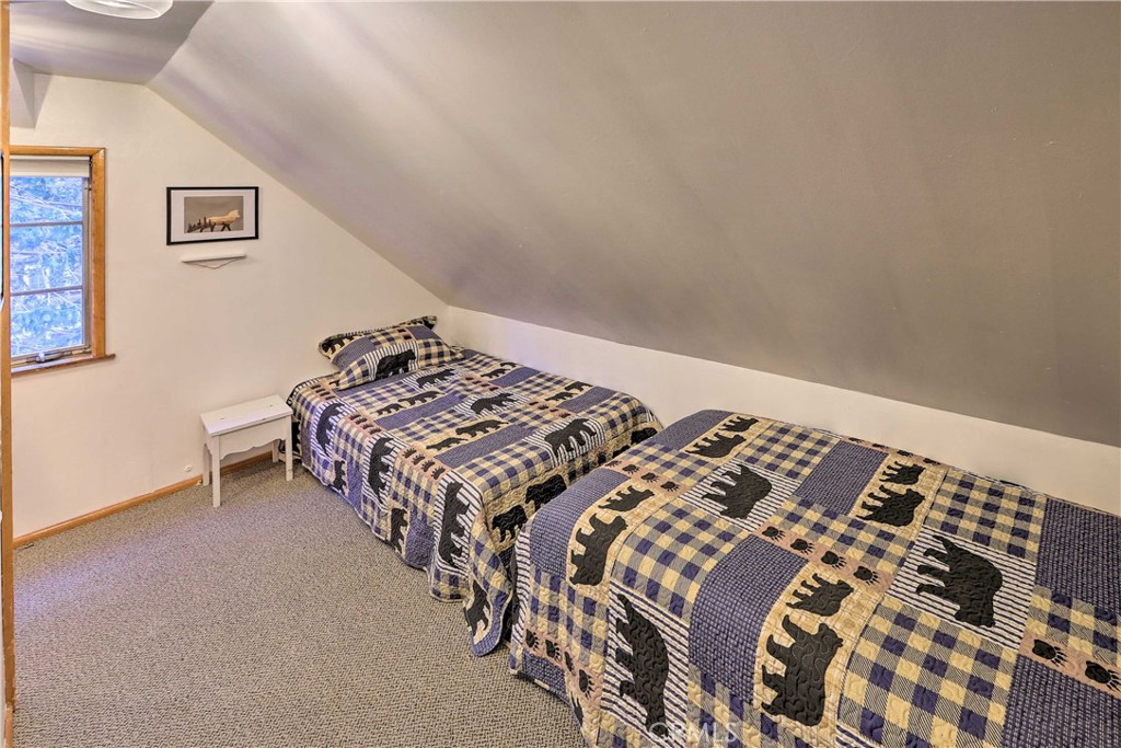 1069 Eagle Road Wrightwood, CA 92397 - Photo 18 of 24 a bed sitting in a bedroom next to a lamp