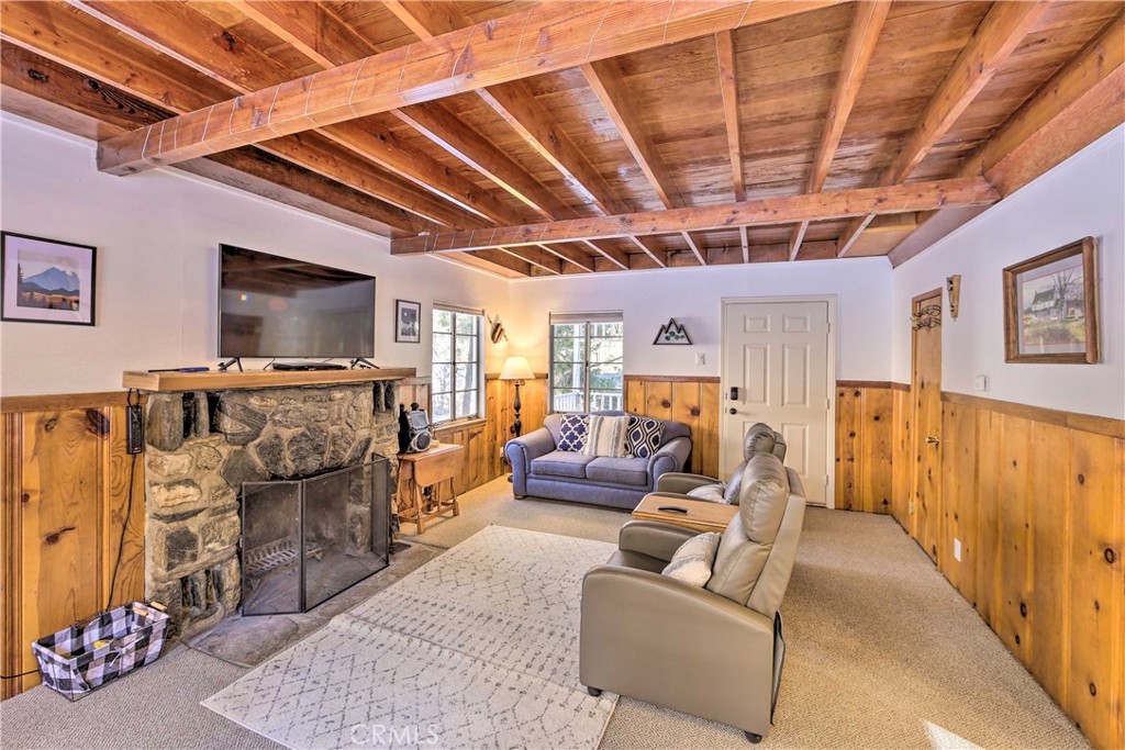 1069 Eagle Road Wrightwood, CA 92397 - Photo 7 of 24 a living room with furniture and a flat screen tv