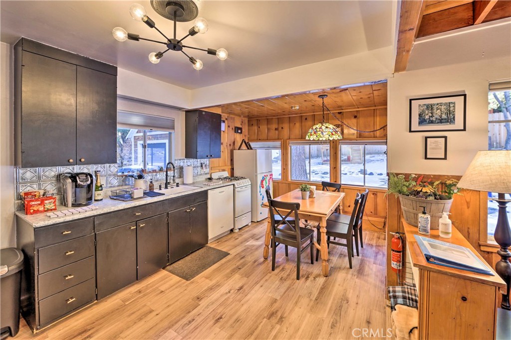 1069 Eagle Road Wrightwood, CA 92397 - Photo 9 of 24 a open kitchen with stainless steel appliances granite countertop a stove dining table chairs and a refrigerator