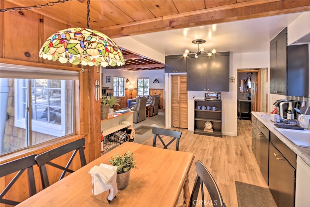 1069 Eagle Road Wrightwood, CA 92397 - Photo 10 of 24 a view of a dining room and livingroom with furniture a chandelier and wooden floor