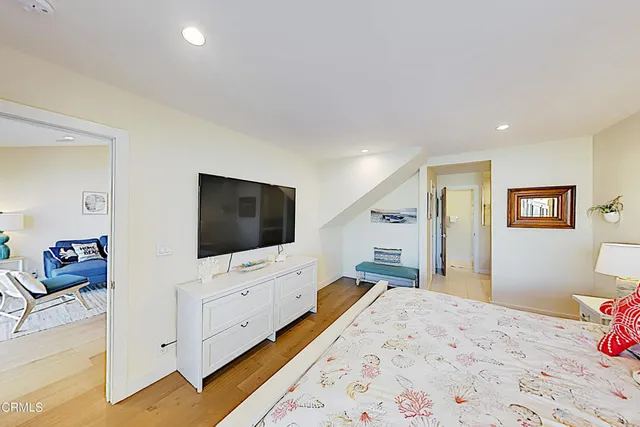 a bedroom with furniture and a flat screen tv