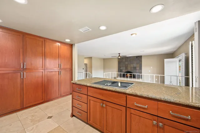 a kitchen with granite countertop a sink and a refrigerator