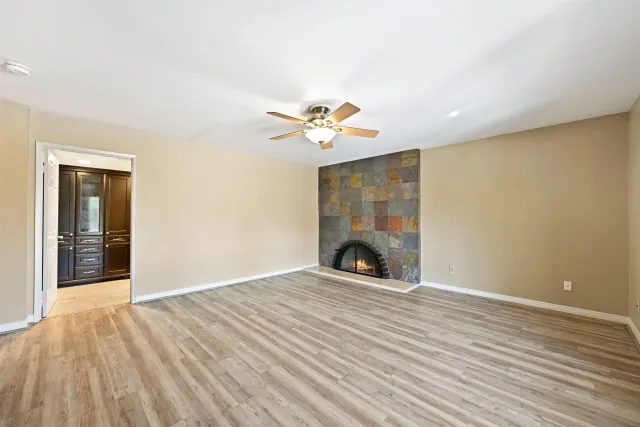 wooden floor in an empty room with a fireplace
