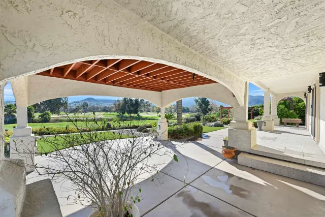 a view of a house with backyard and sitting area