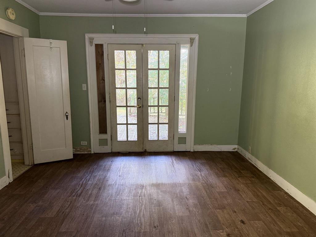 100 Smith Street Naples, TX 75568 - Photo 13 of 30 a view of an empty room with wooden floor and a window