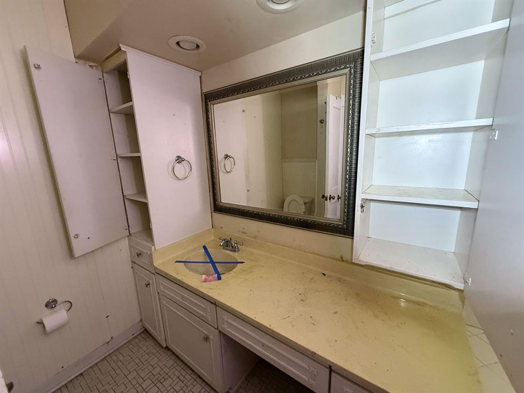 100 Smith Street Naples, TX 75568 - Photo 18 of 30 a bathroom with a sink and a mirror