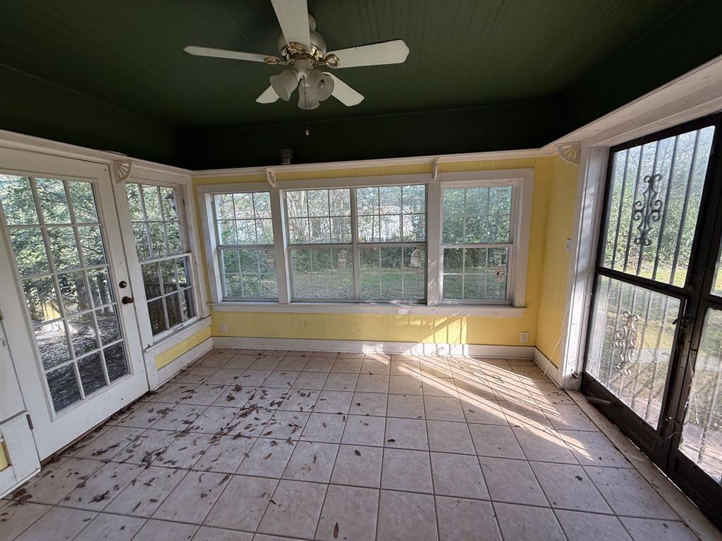 100 Smith Street Naples, TX 75568 - Photo 22 of 30 a view of empty room with wooden floor and fan