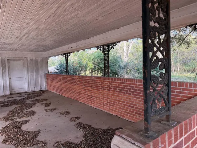 a view of a backyard with large trees