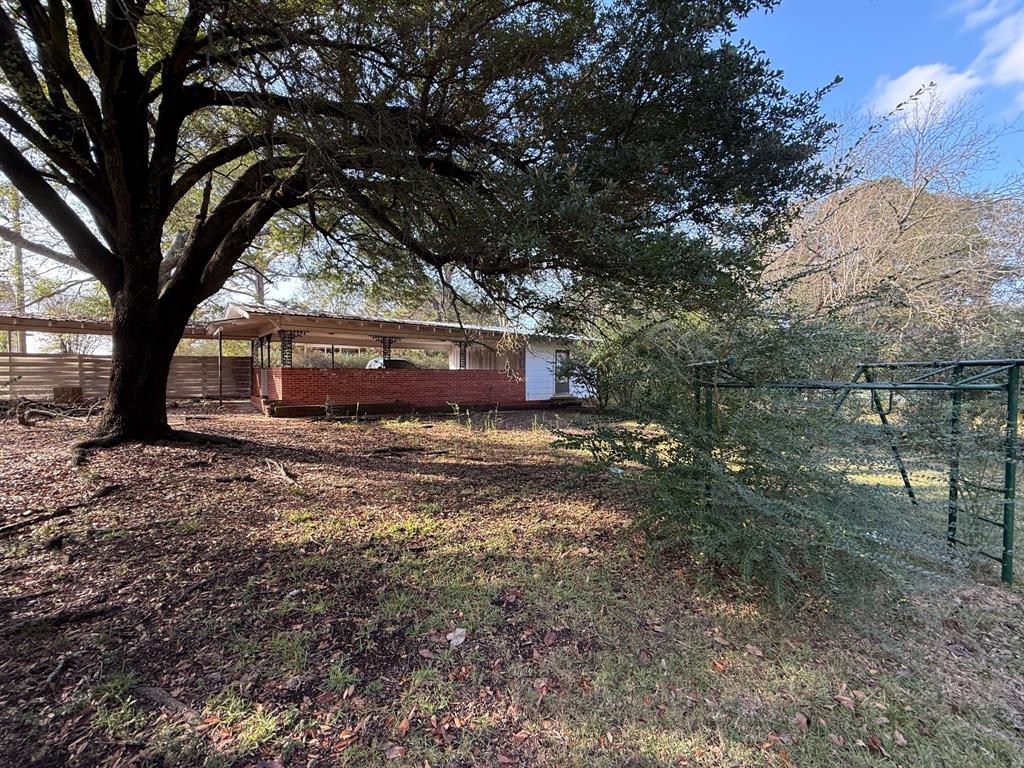 100 Smith Street Naples, TX 75568 - Photo 26 of 30 a view of a house with a yard