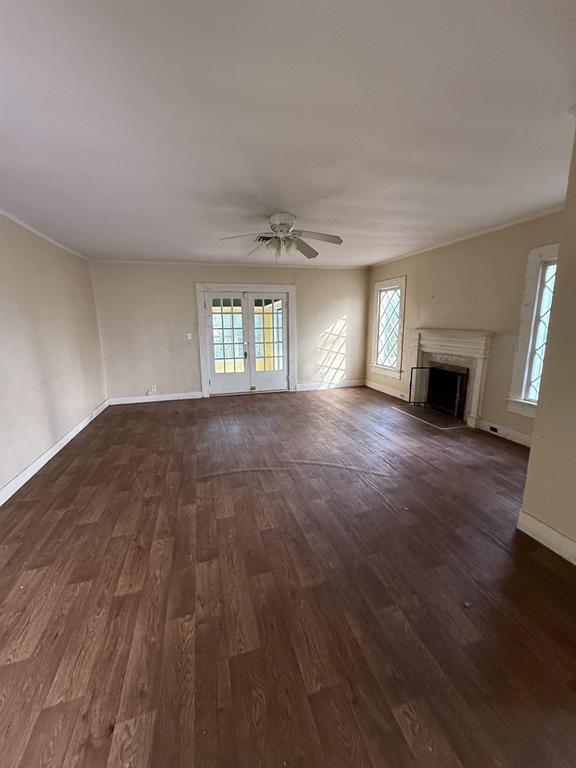100 Smith Street Naples, TX 75568 - Photo 4 of 30 an empty room with wooden floor and fireplace