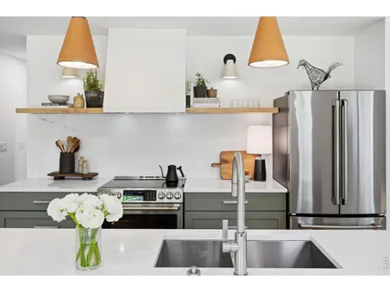 a kitchen with stainless steel appliances kitchen island granite countertop a sink and a stove