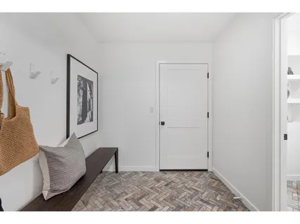 a view of an empty room and wooden floor