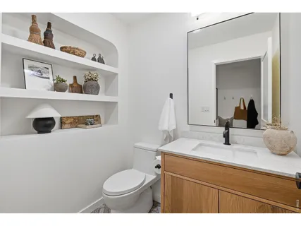 a bathroom with a sink a toilet and a mirror