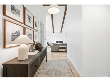 a living room with furniture and a painting on the wall