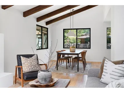 a dining room with furniture and wooden floor