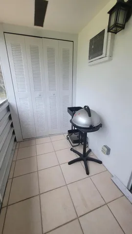 a view of a room with a wooden floor and a cabinet