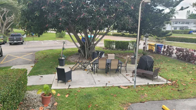a view of a chairs and table in backyard